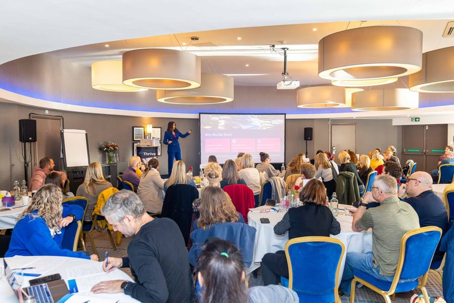 Katie Bell coaching clinic owners at a live event