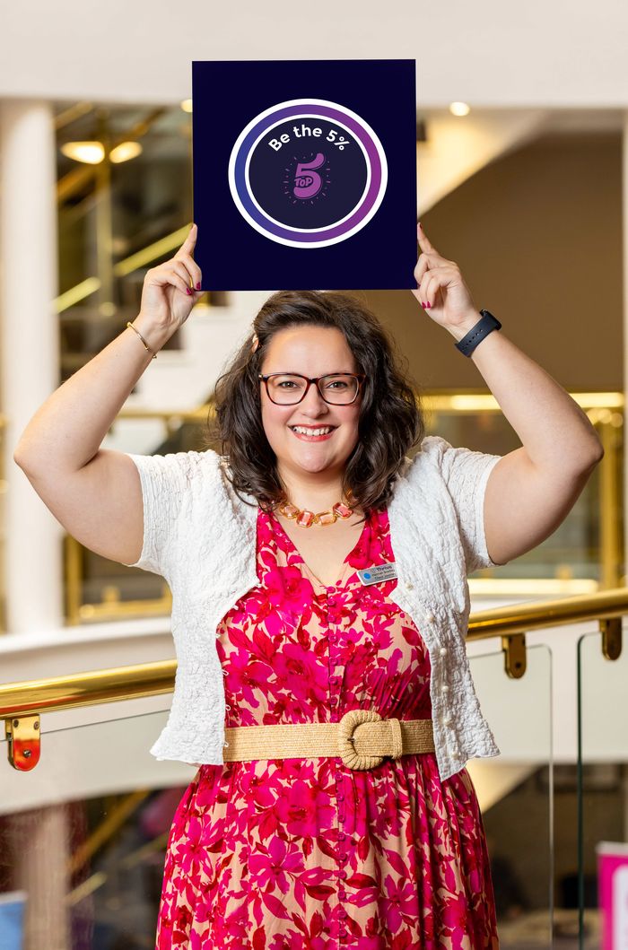 Hannah Bradley holding the Be the 5% values board