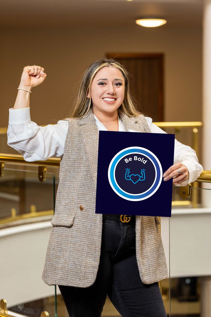 Jodie Rushin holding the Be Bold values board