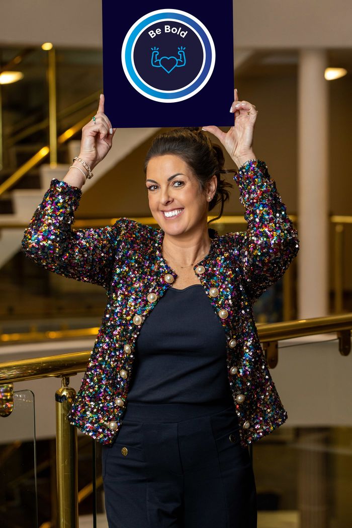 Katie Bell holding the Be Bold values board